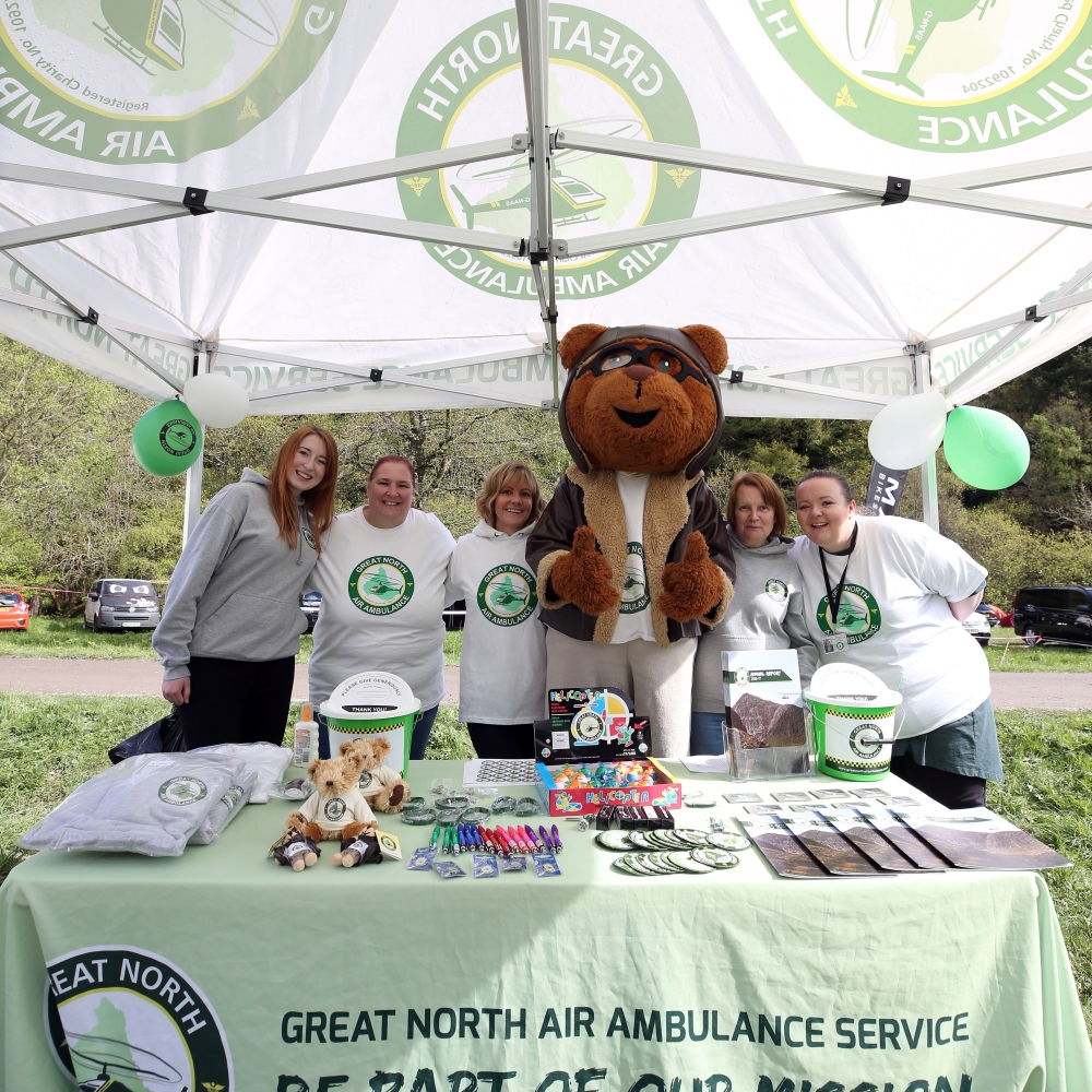 gnaas fundraisers and miles the bear at merchandise stall