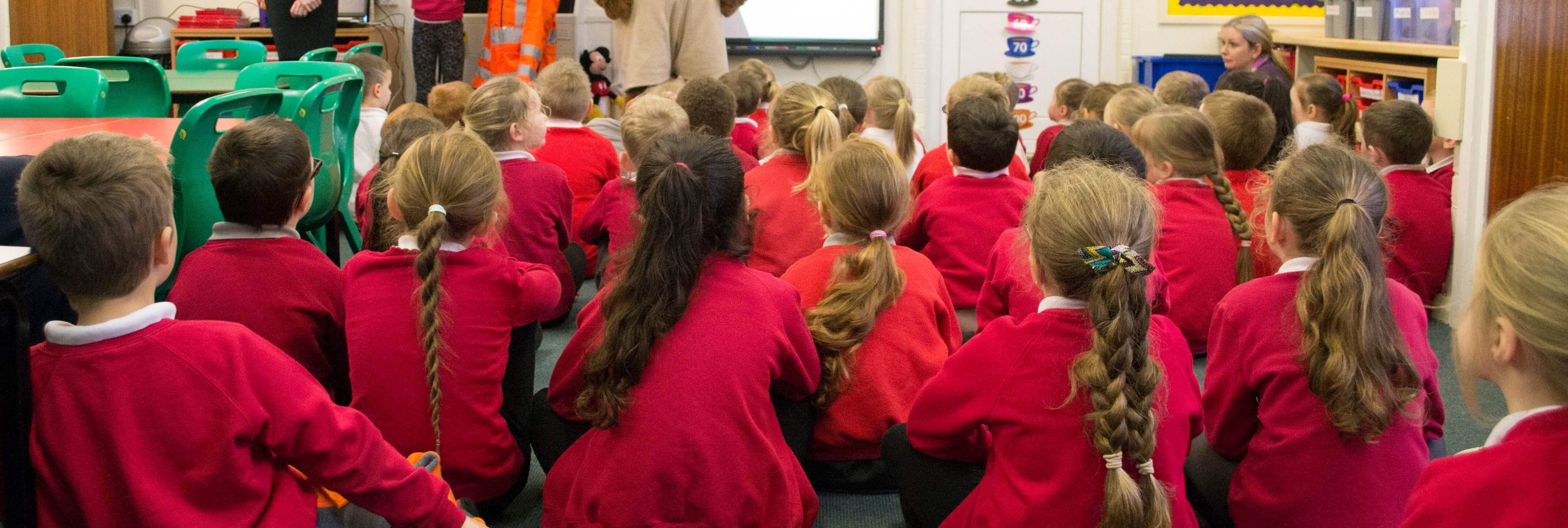 pupils sat in school watching gnaas presentation