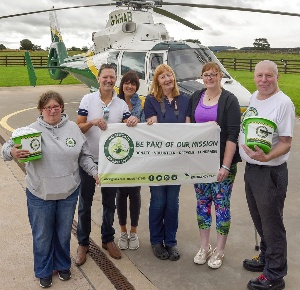 Fundraising volunteers with GNAAS banner at langwathby base