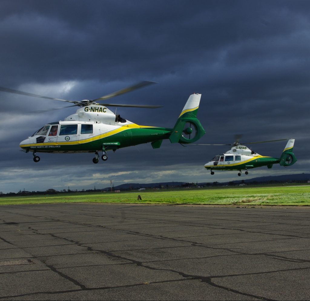 G-NHAA, G-NHAB, G-NHAC - the three GNAAS helicopters, in flight