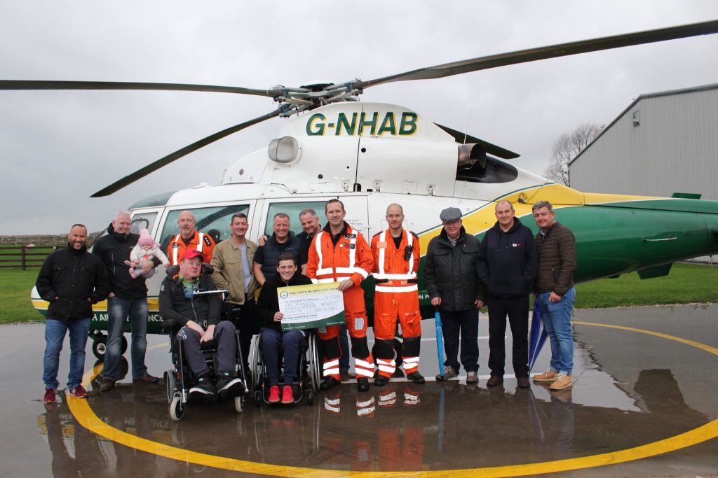 Sam Beecroft and members of Toon to Town present a cheque to GNAAS