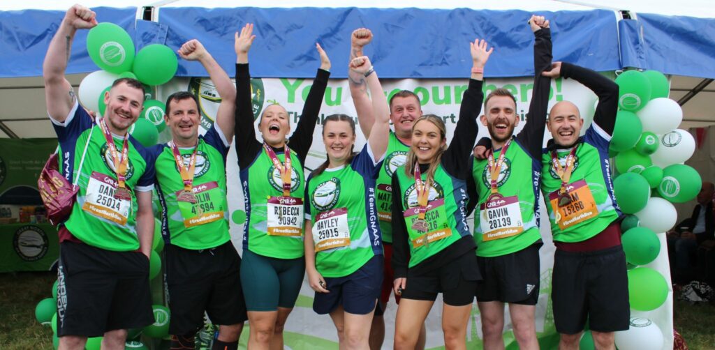 Group of runners posing after finishing sponsored run for GNAAS.