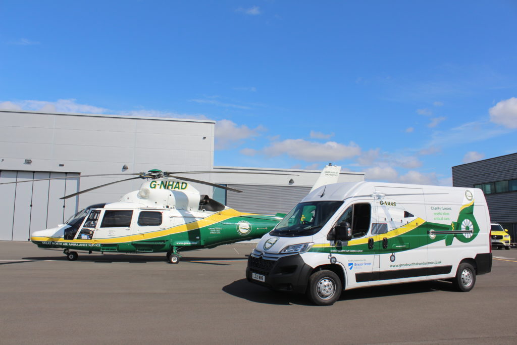 GNAAS Trading Company van alongside the GNAAS Aircraft.